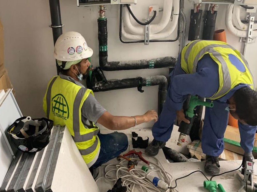 Technicians completing plumbing installation