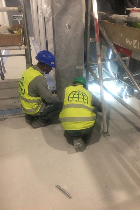 Technicians installing structural fittings