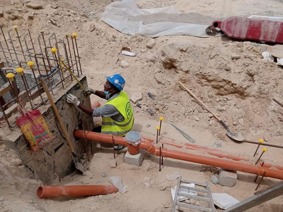 Technician installing utility pipework